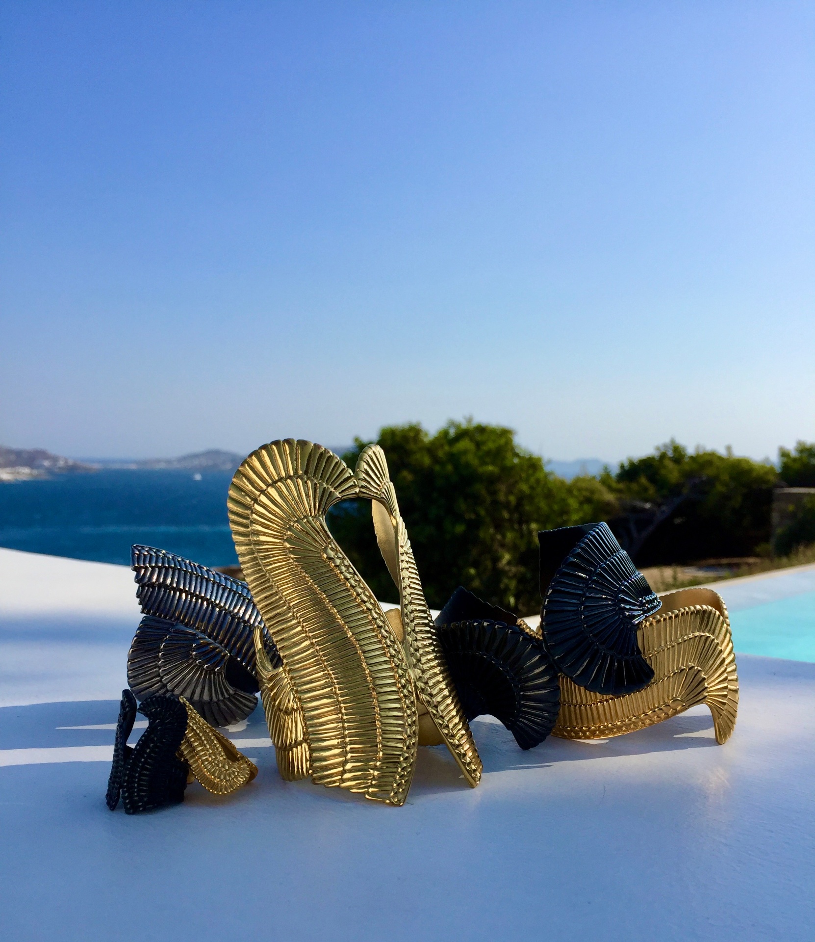 Neda Tahniat gold cuffs by the sea