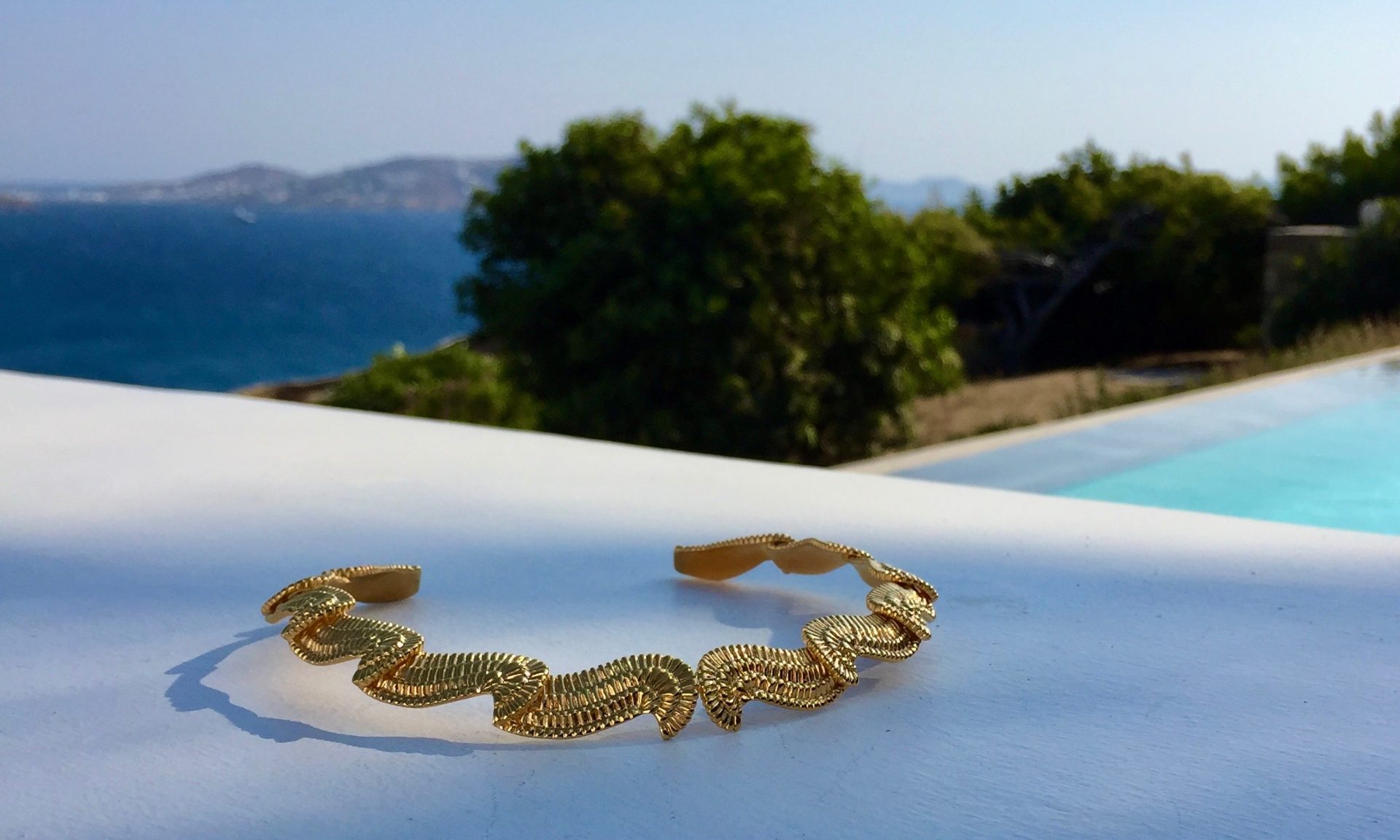 Gold bracelet by the pool